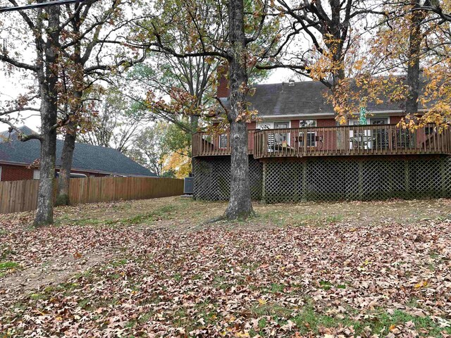 view of yard featuring a wooden deck and cooling unit