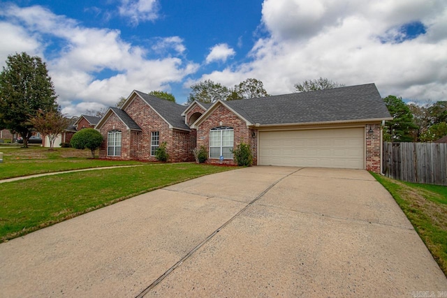 single story home featuring a front yard and a garage