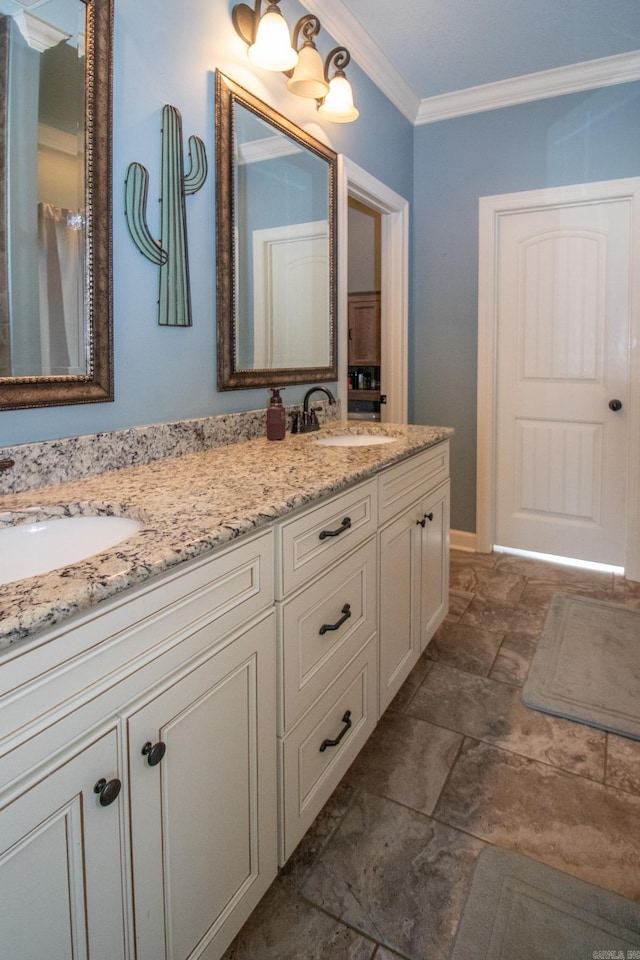 bathroom featuring double vanity, ornamental molding, and a sink