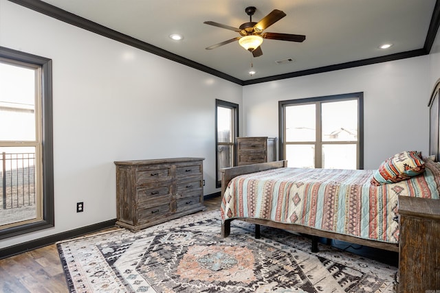 bedroom featuring recessed lighting, visible vents, ornamental molding, wood finished floors, and baseboards