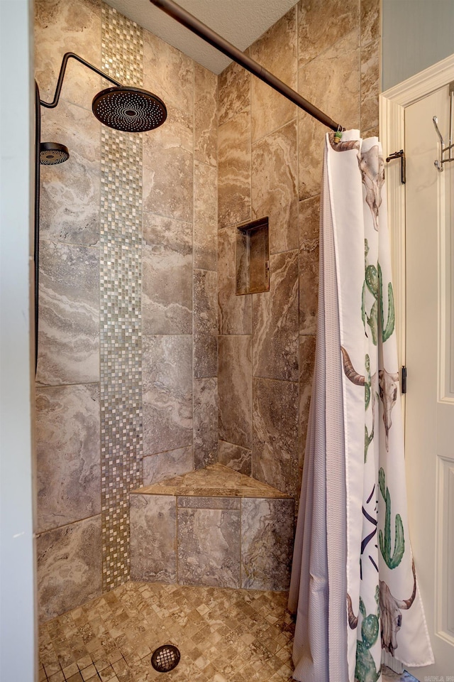 bathroom with a tile shower