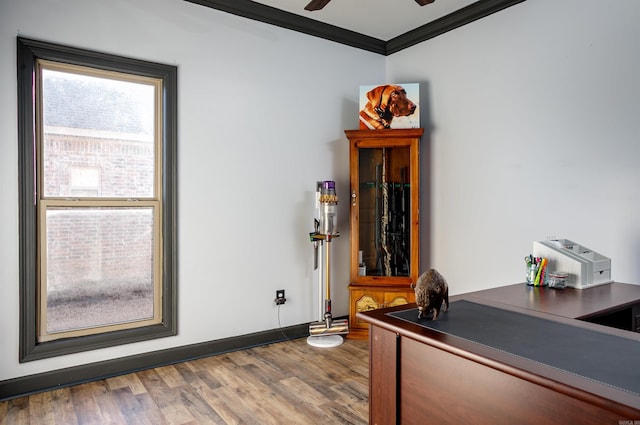 home office with a ceiling fan, crown molding, baseboards, and wood finished floors