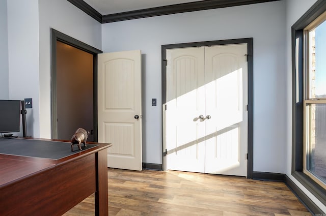 home office with crown molding, baseboards, and wood finished floors