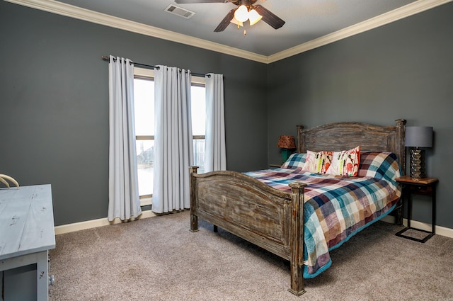 carpeted bedroom featuring baseboards, visible vents, ceiling fan, and crown molding