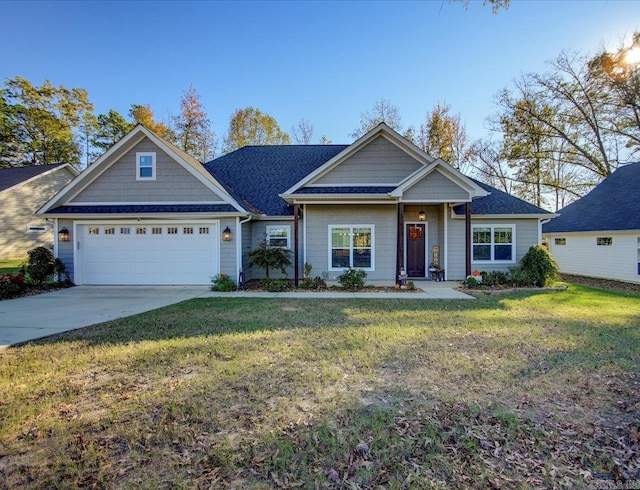 view of front of home with a front yard and a garage