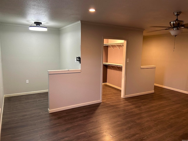 interior space featuring a textured ceiling, dark hardwood / wood-style flooring, ceiling fan, and crown molding