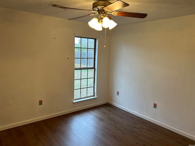 unfurnished room with ceiling fan and dark wood-type flooring