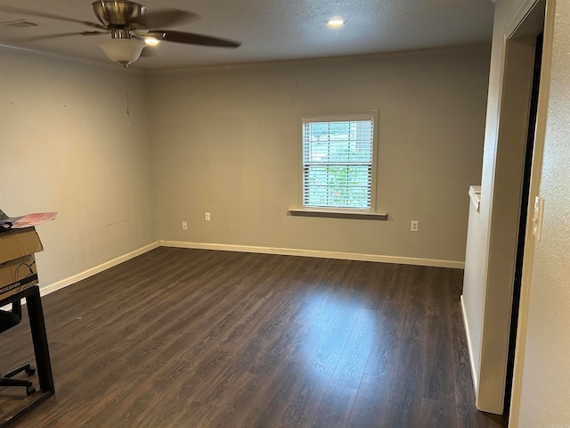 unfurnished room featuring ceiling fan and dark hardwood / wood-style flooring