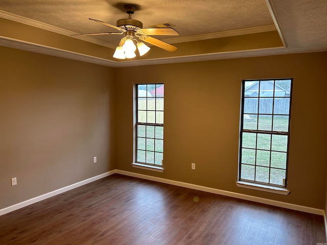 empty room with a textured ceiling, dark hardwood / wood-style floors, ceiling fan, and crown molding