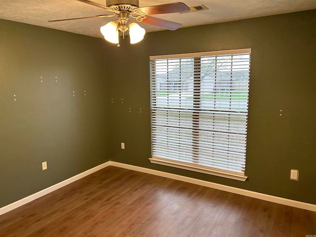 spare room featuring a textured ceiling, hardwood / wood-style flooring, and ceiling fan