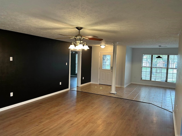 foyer with ceiling fan, a textured ceiling, and hardwood / wood-style flooring