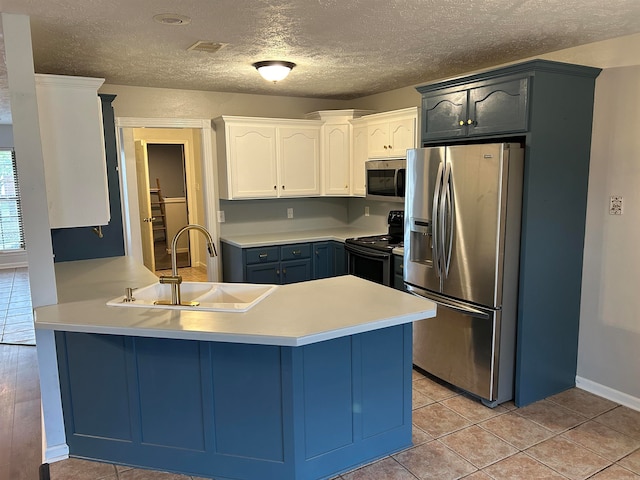 kitchen featuring white cabinets, sink, light tile patterned floors, kitchen peninsula, and stainless steel appliances