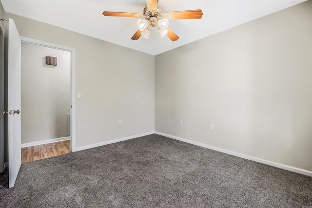 carpeted spare room with ceiling fan