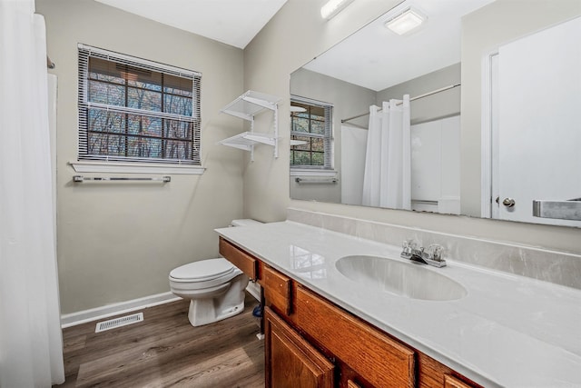 bathroom featuring hardwood / wood-style flooring, vanity, toilet, and a shower with shower curtain