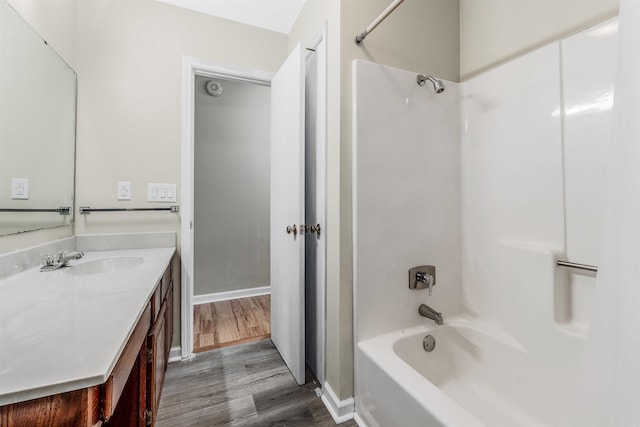 bathroom featuring vanity, wood-type flooring, and bathtub / shower combination