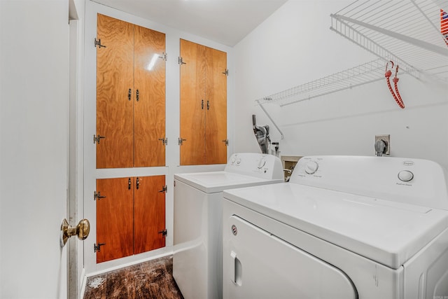 laundry area featuring washing machine and dryer and wood-type flooring