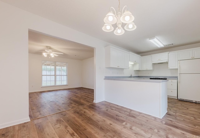 kitchen with white cabinetry, light hardwood / wood-style flooring, white refrigerator, kitchen peninsula, and ceiling fan with notable chandelier