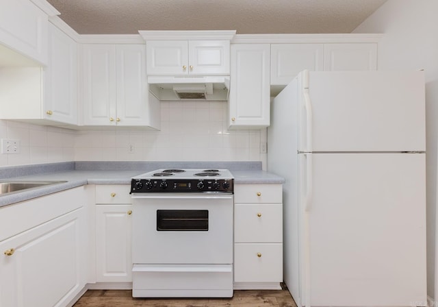 kitchen with white cabinets, custom range hood, white appliances, and hardwood / wood-style floors