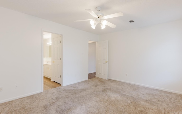 unfurnished bedroom with connected bathroom, ceiling fan, and light colored carpet