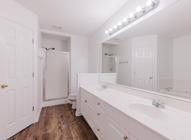 full bathroom with vanity, toilet, wood-type flooring, and shower with separate bathtub