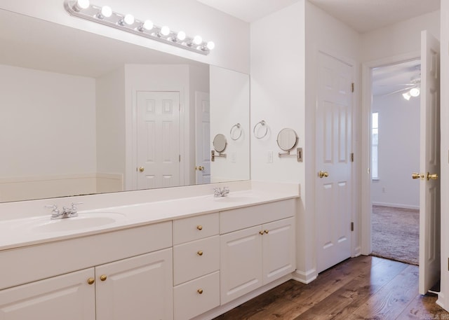 bathroom with ceiling fan, vanity, and hardwood / wood-style flooring