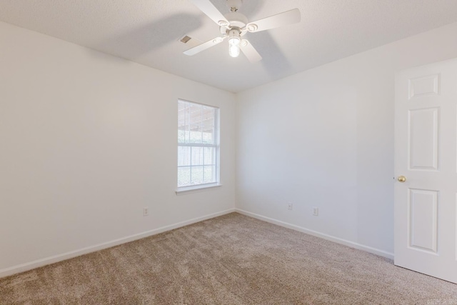 empty room featuring carpet flooring and ceiling fan