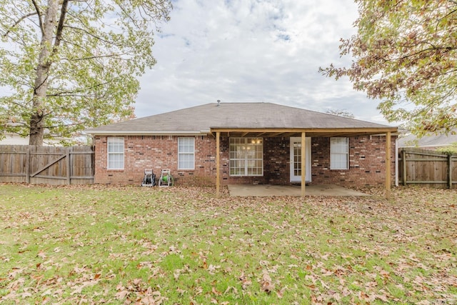 rear view of property with a patio area and a lawn