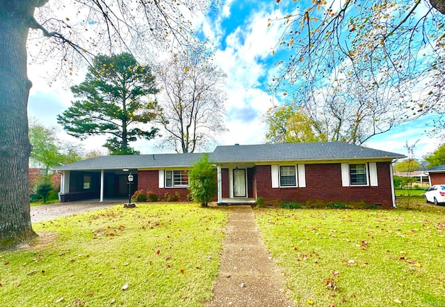 single story home with a front yard and a carport