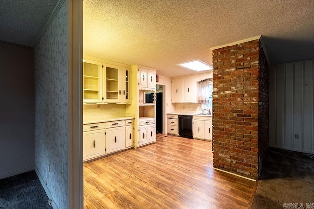 713 N Spring St, Searcy, AR 72143 - kitchen with dishwasher, a sink, light countertops, light wood-type flooring, and a textured ceiling
