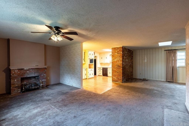 713 N Spring St, Searcy, AR 72143 - unfurnished living room with a textured ceiling, light colored carpet, a brick fireplace, and a ceiling fan