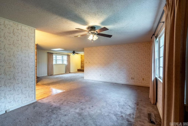 713 N Spring St, Searcy, AR 72143 - carpeted empty room with wallpapered walls, a ceiling fan, a textured ceiling, and baseboards