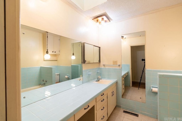 713 N Spring St, Searcy, AR 72143 - full bath featuring tile walls, tile patterned flooring, wainscoting, vanity, and crown molding