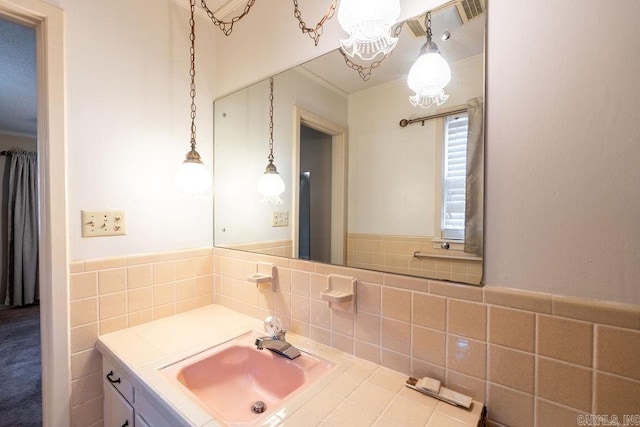 713 N Spring St, Searcy, AR 72143 - bathroom with ornamental molding, vanity, tile walls, and a chandelier