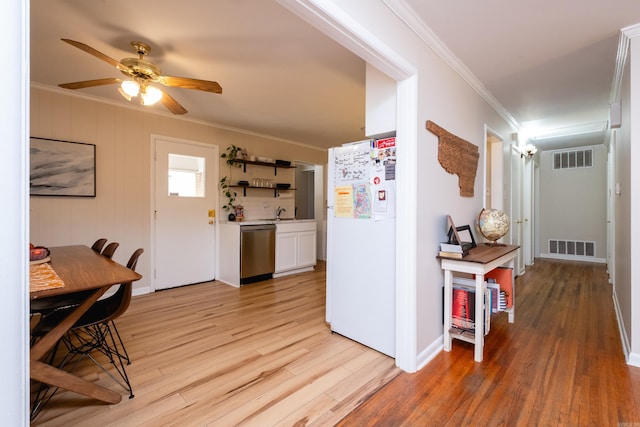 interior space with light wood-type flooring and ornamental molding