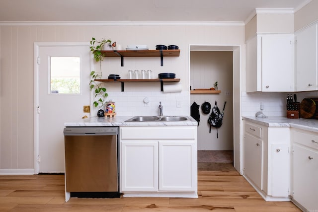 kitchen featuring decorative backsplash, white cabinetry, sink, and stainless steel dishwasher