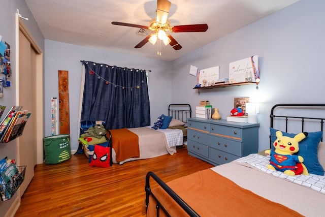 bedroom with ceiling fan and wood-type flooring