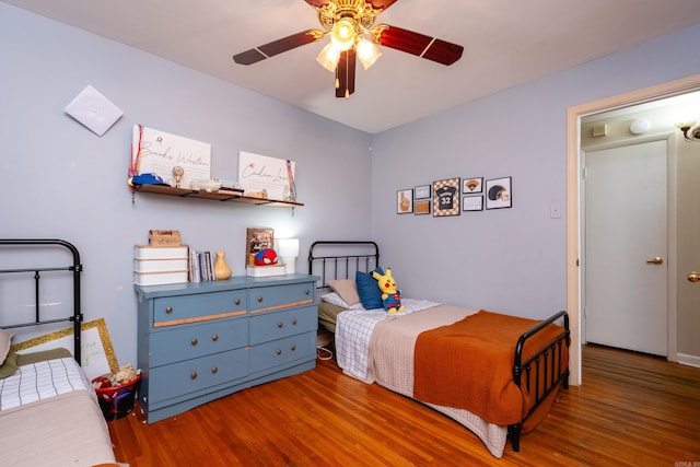 bedroom with wood-type flooring and ceiling fan