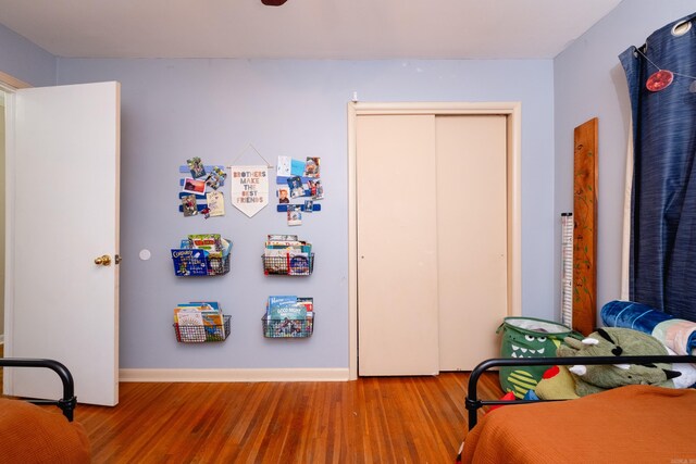 bedroom featuring hardwood / wood-style flooring and a closet