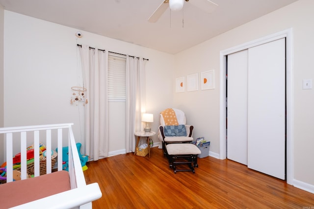 bedroom with ceiling fan, a closet, and hardwood / wood-style flooring