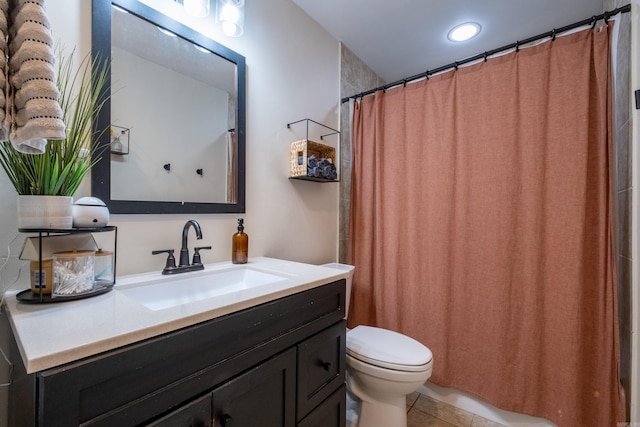 bathroom with tile patterned flooring, vanity, and toilet