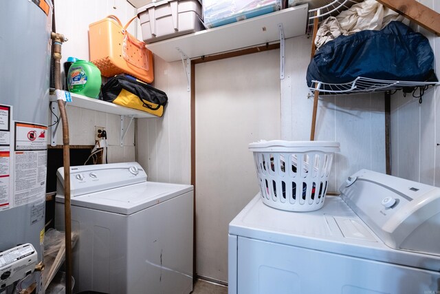 washroom with washer and dryer and water heater