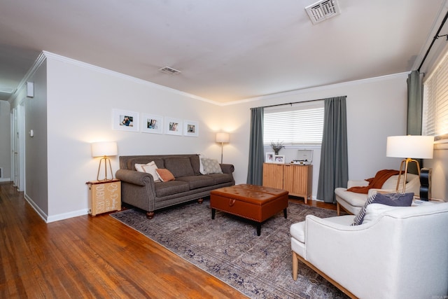 living room featuring dark hardwood / wood-style flooring and ornamental molding