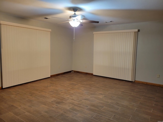 unfurnished room featuring ceiling fan and dark wood-type flooring