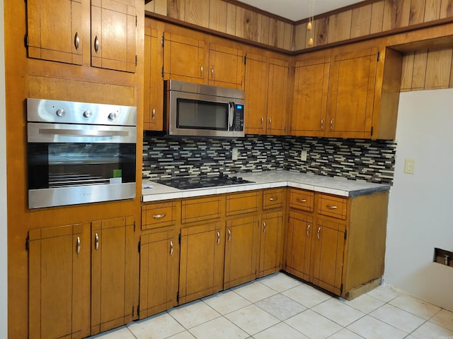 kitchen featuring appliances with stainless steel finishes, tasteful backsplash, and light tile patterned floors