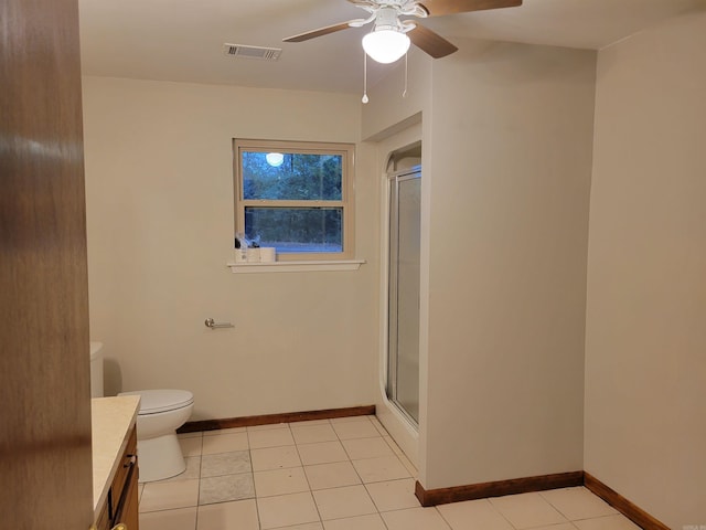 bathroom featuring vanity, ceiling fan, tile patterned flooring, toilet, and a shower with shower door