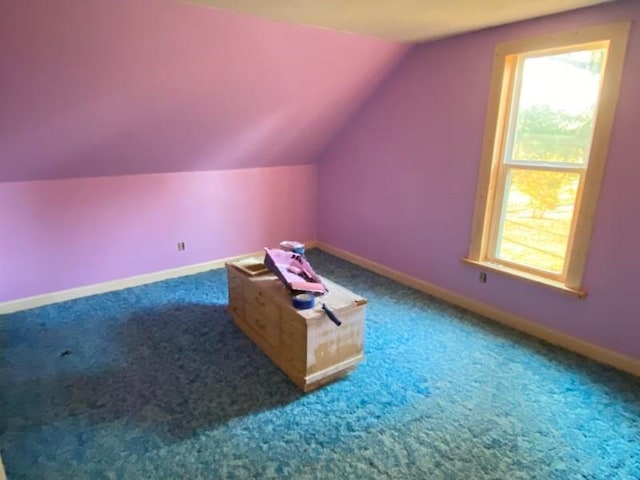 additional living space with carpet and lofted ceiling