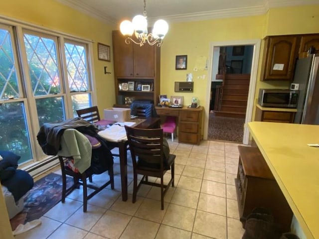 tiled dining room featuring a baseboard heating unit, an inviting chandelier, and crown molding