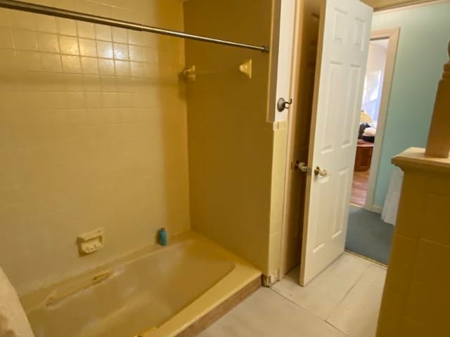 bathroom featuring tile patterned floors and tiled shower / bath