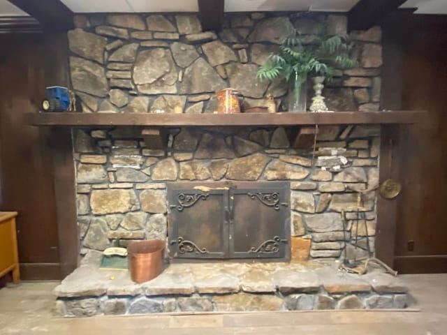 details featuring a stone fireplace and concrete flooring