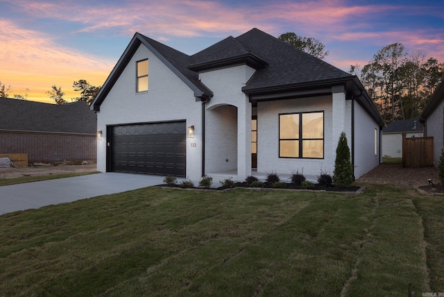 view of front of property with a yard and a garage